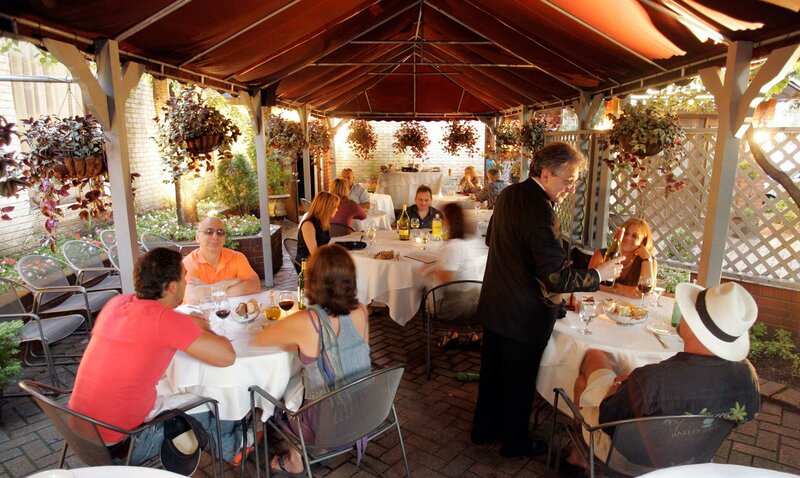 Outdoor dining with guests enjoying their meal