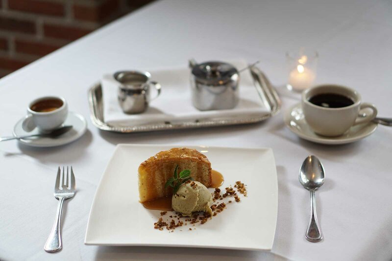 Cake dessert with side of ice cream and coffee drinks