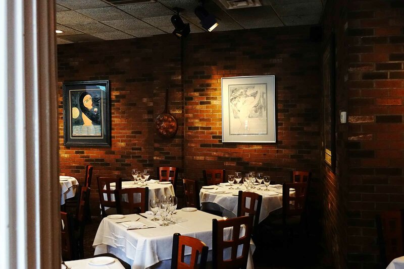 Dining room with view of multiple set tables